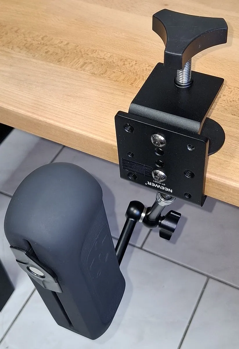 The Handy 2 held under a desk edge by a clamp and an arm