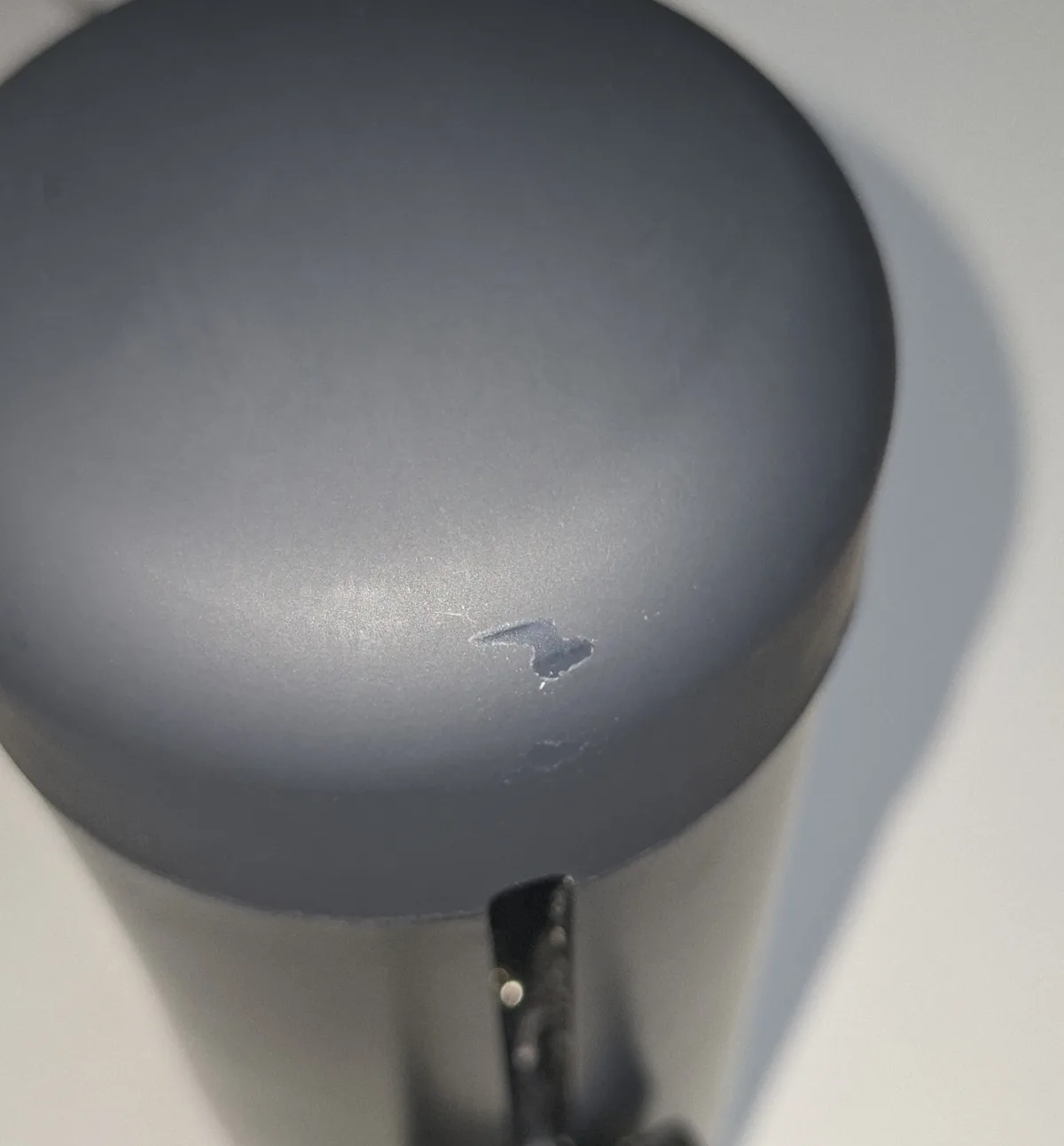 Close up of the top of a Handy showing a small patch where the soft touch coating has flaked away
