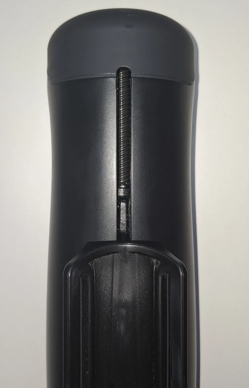 The drive screw of a Handy seen through the slot in the body, with fresh grease visible on the thread