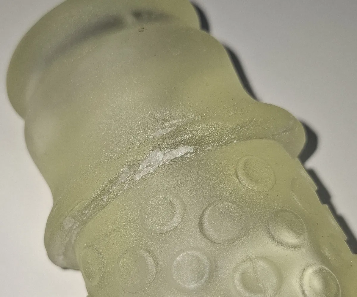 Close-up of a yellowed Handy Lips sleeve showing the surface becoming porous after three years of use