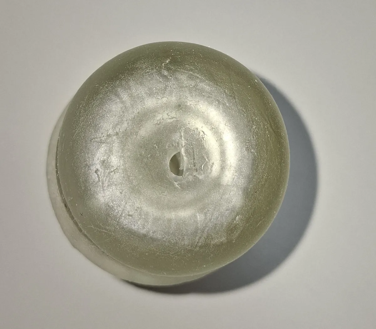 The closed end of a Handy Lips sleeve seen from above, with the small scissor-cut hole used to add lube without dismantling the setup