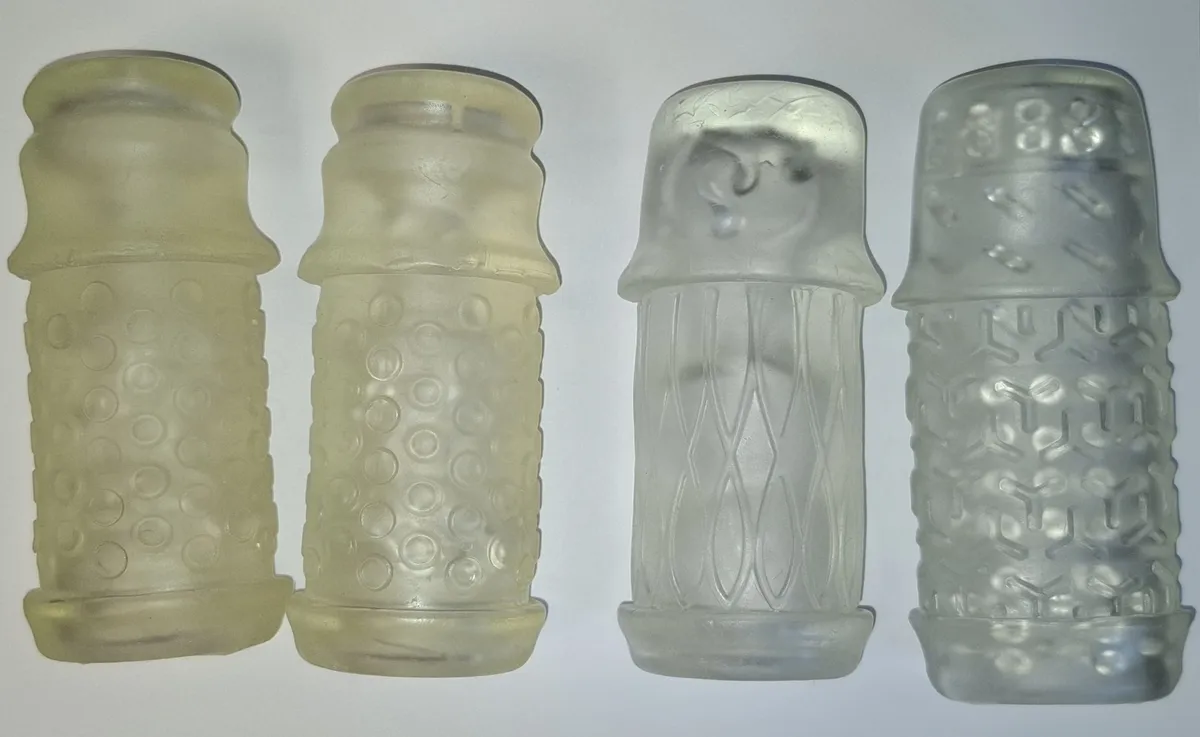 Four Handy sleeves photographed side by side in the same frame: the two Lips on the left have yellowed noticeably, the Lotus and the TrueGrip Gen 2 on the right have kept their original colour